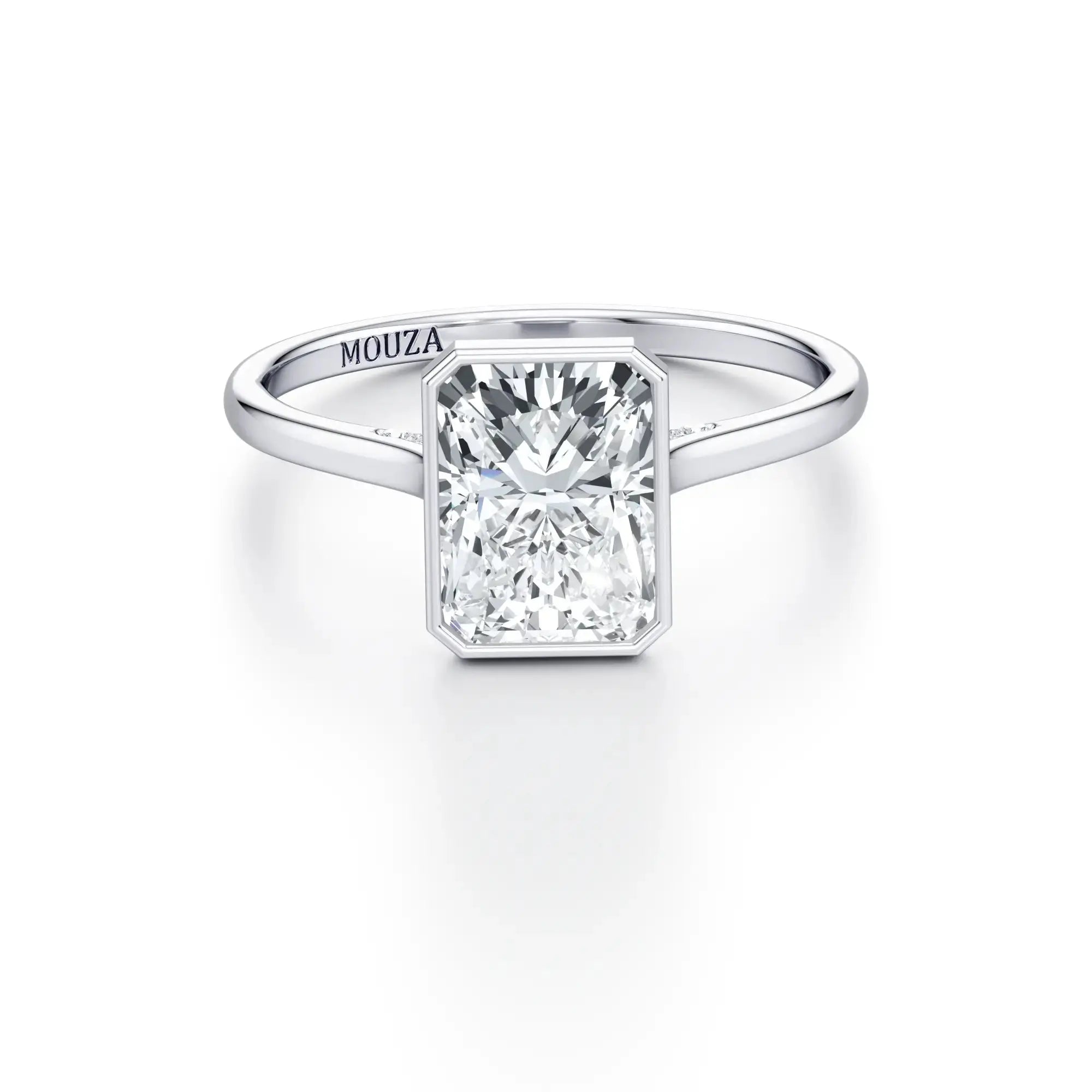 A white gold bezel set engagement ring with a clear central stone and micro-set stones on the bridge, labeled 'MOUZA' on the band.