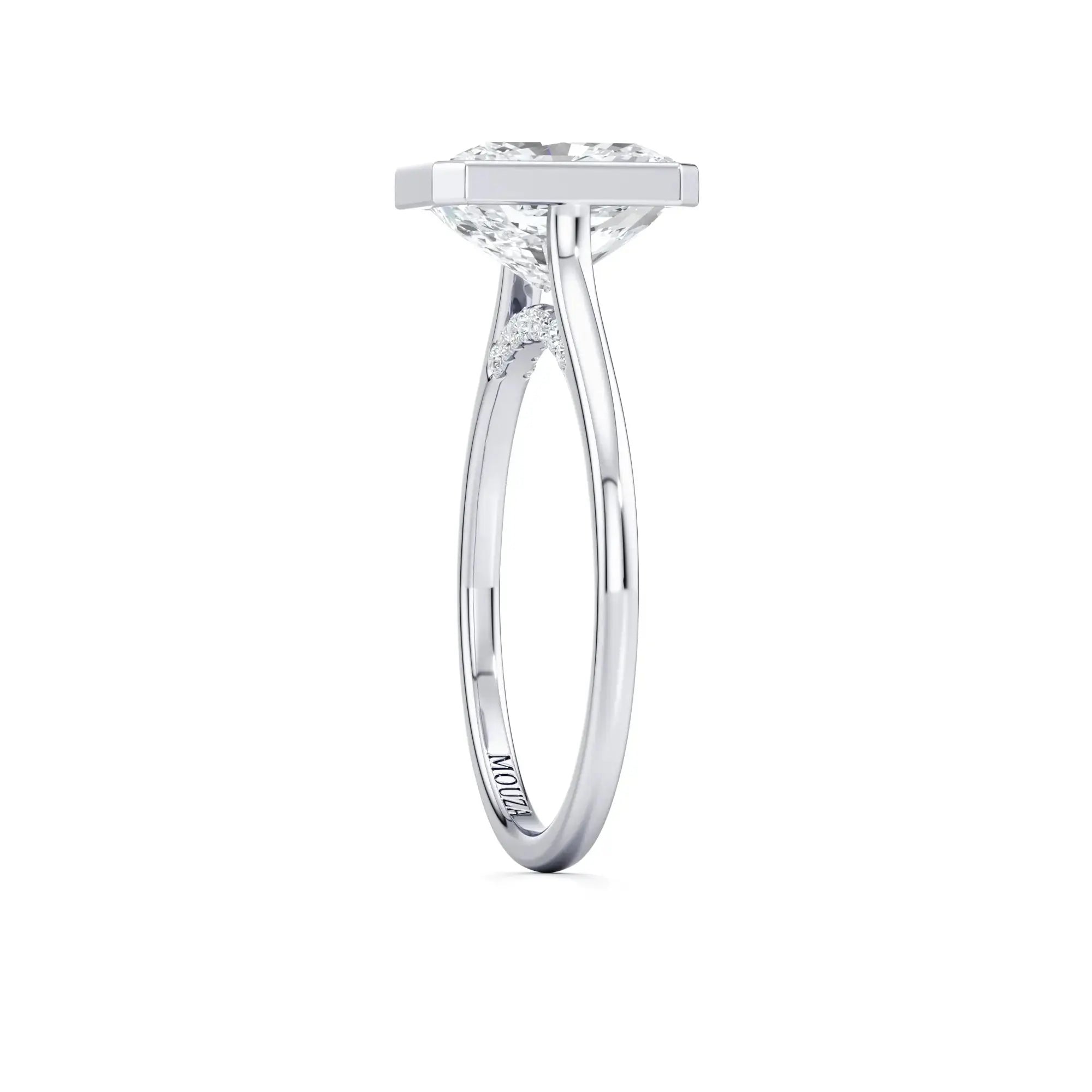 White gold bezel set diamond engagement ring, labeled 'MOUZA' on the band.