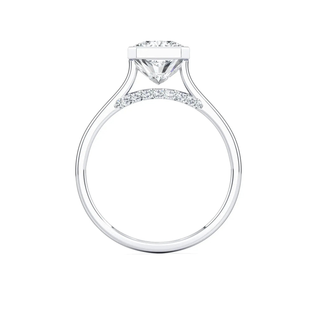 Radiant white gold bezel set diamond engagement ring, labeled 'MOUZA' on the band.