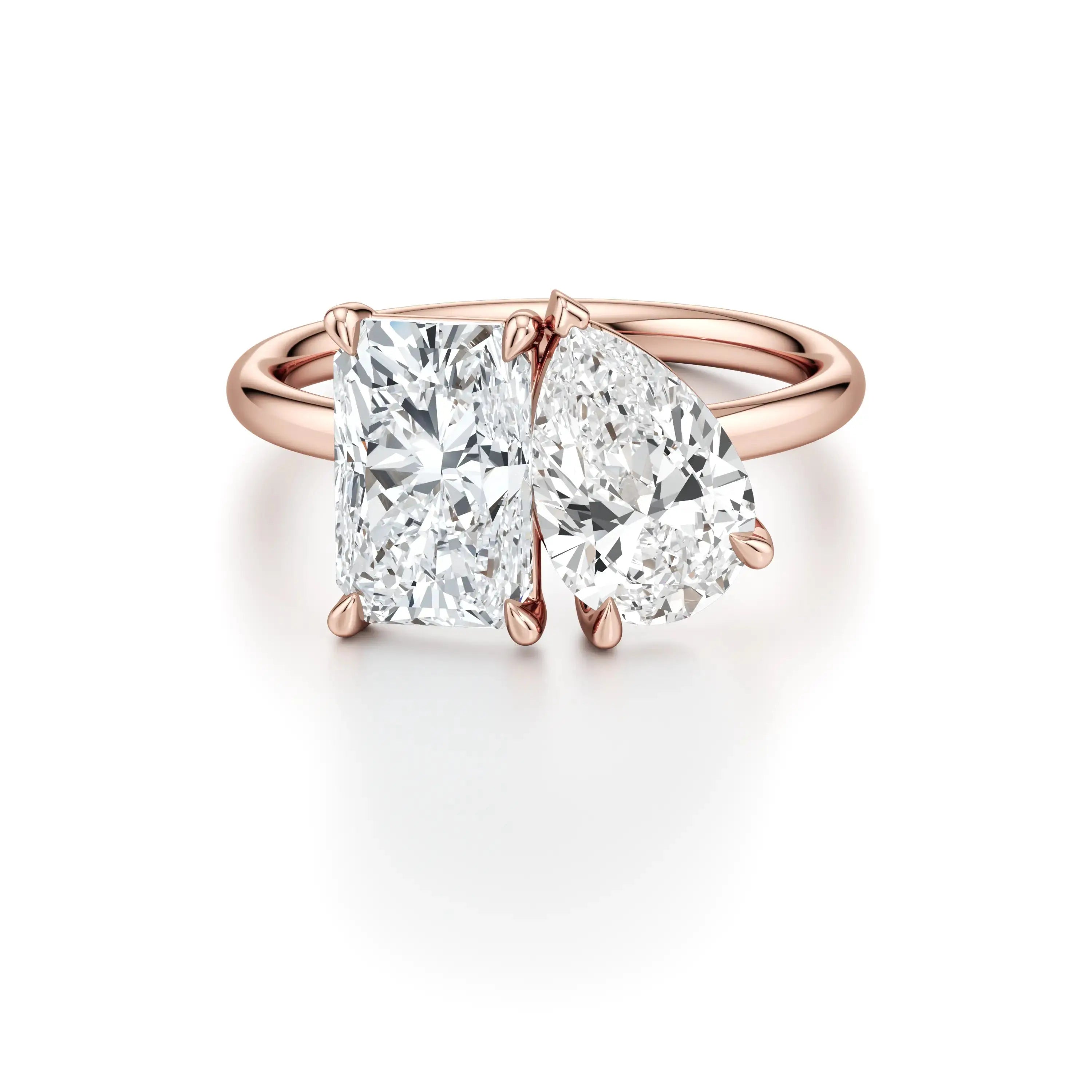 A rose gold engagement ring with a classic floating band design, featuring two cushion-cut diamond center stones.