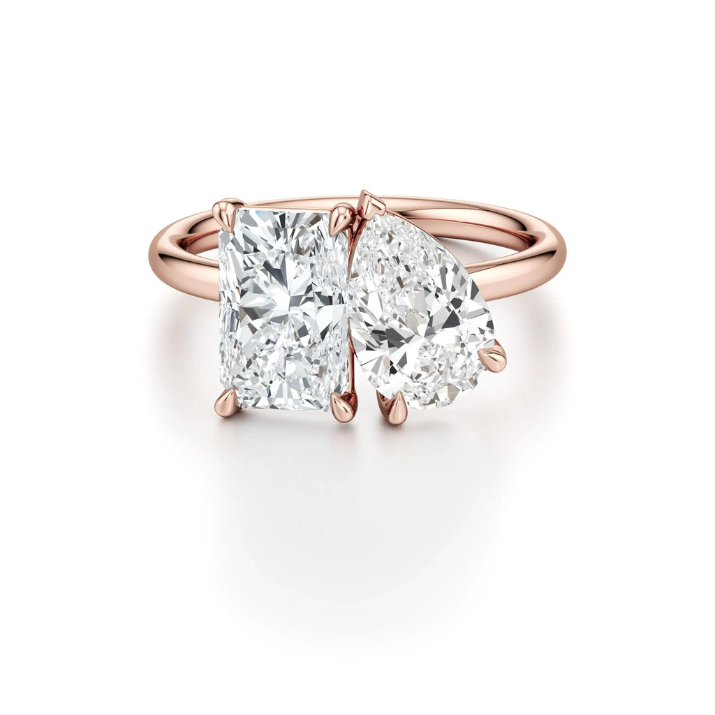 A rose gold engagement ring with a classic floating band design, featuring two cushion-cut diamond center stones.