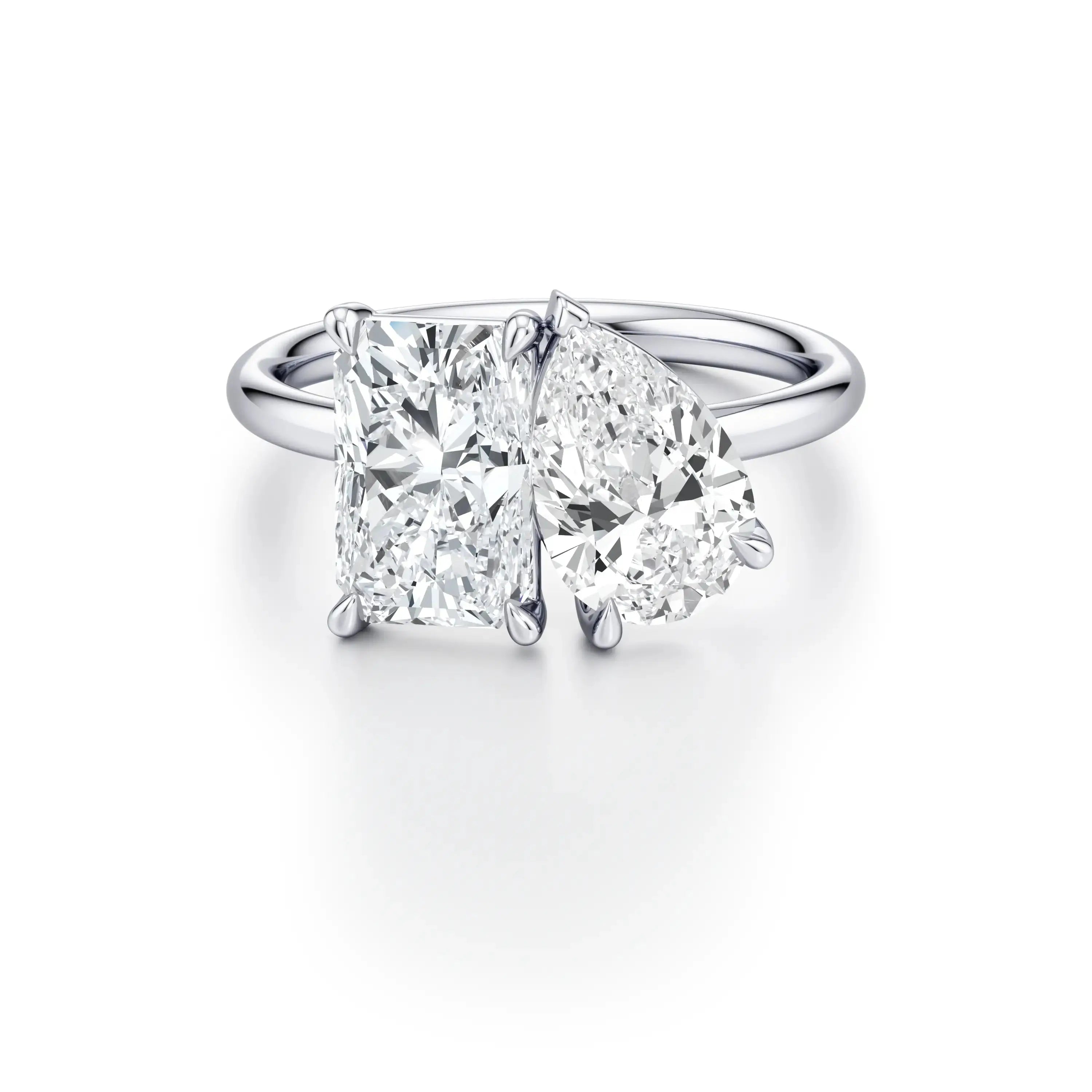 A platinum engagement ring with a classic floating band design, featuring two cushion-cut diamond center stones.