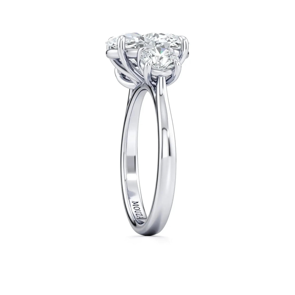 A classic trilogy diamond band engagement ring having the brand name 'Mouza' on it.