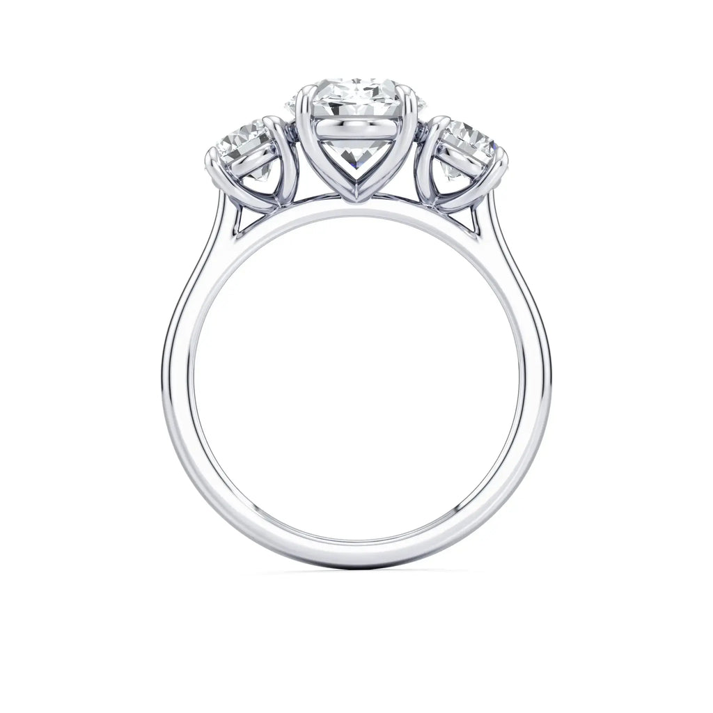A classic three-stone diamond engagement ring with round side stones and a central oval diamond