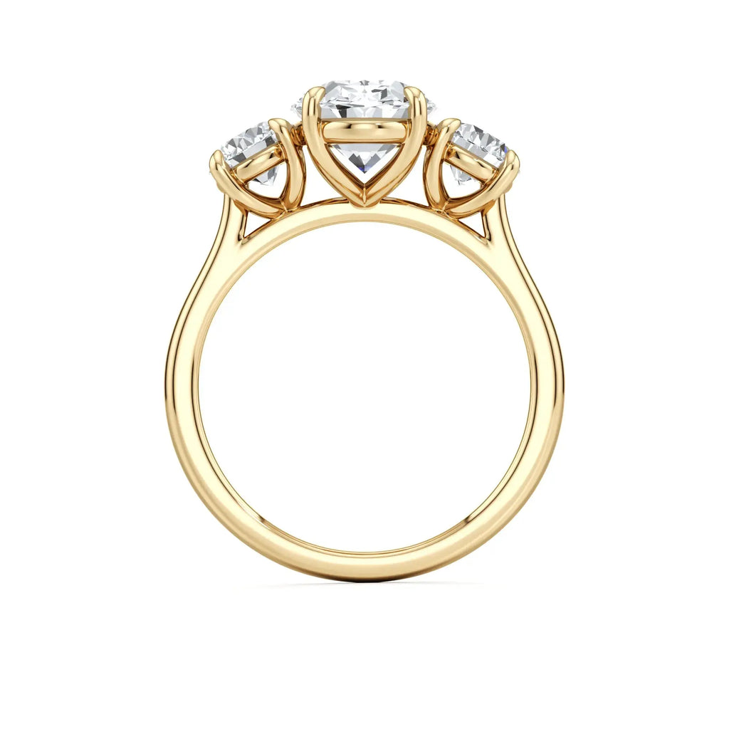 A classic trilogy diamond engagement ring with a central oval diamond, with a gold band having the brand name 'Mouza' on it.