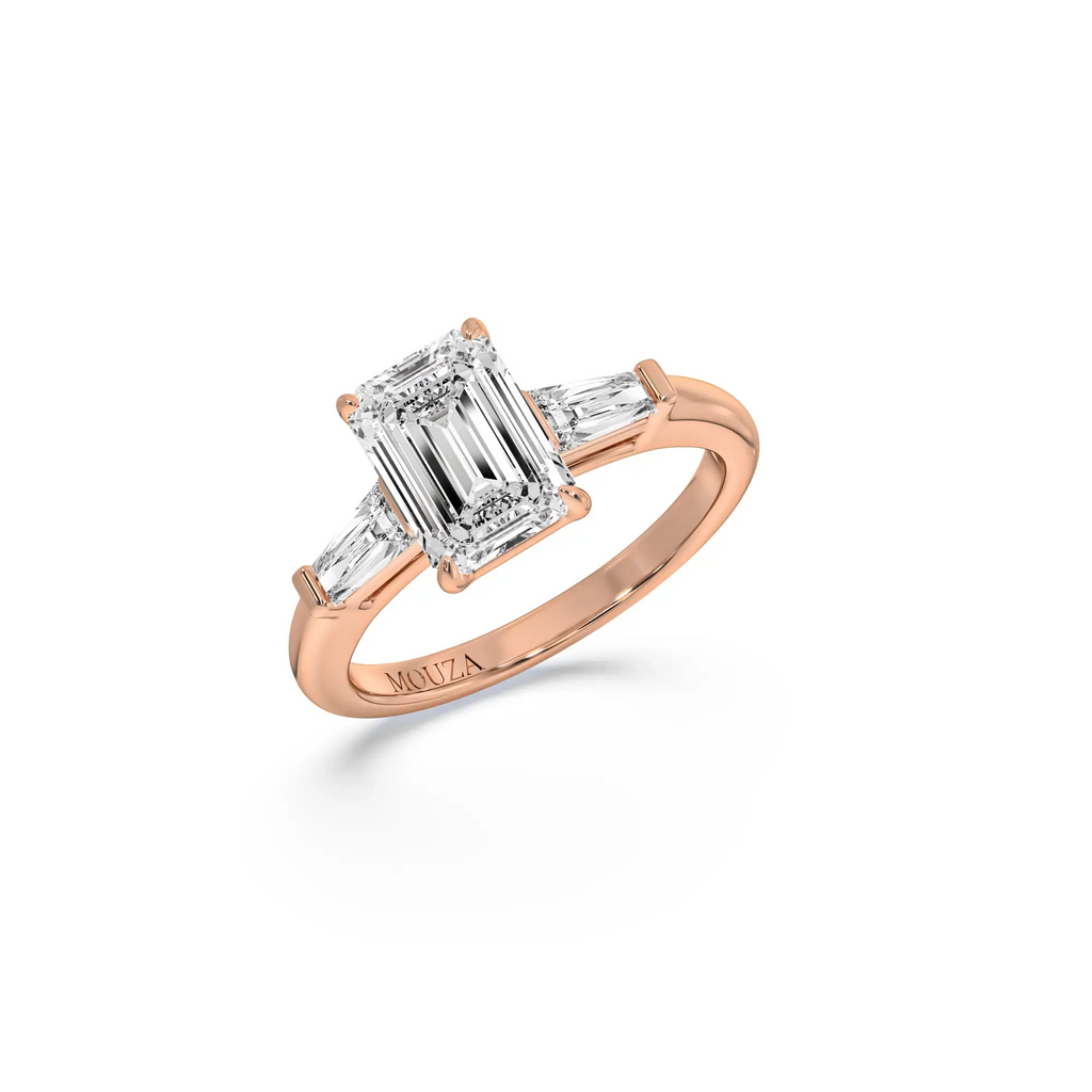 A sleek emerald-cut diamond engagement ring in 18K rose gold band from Mouza