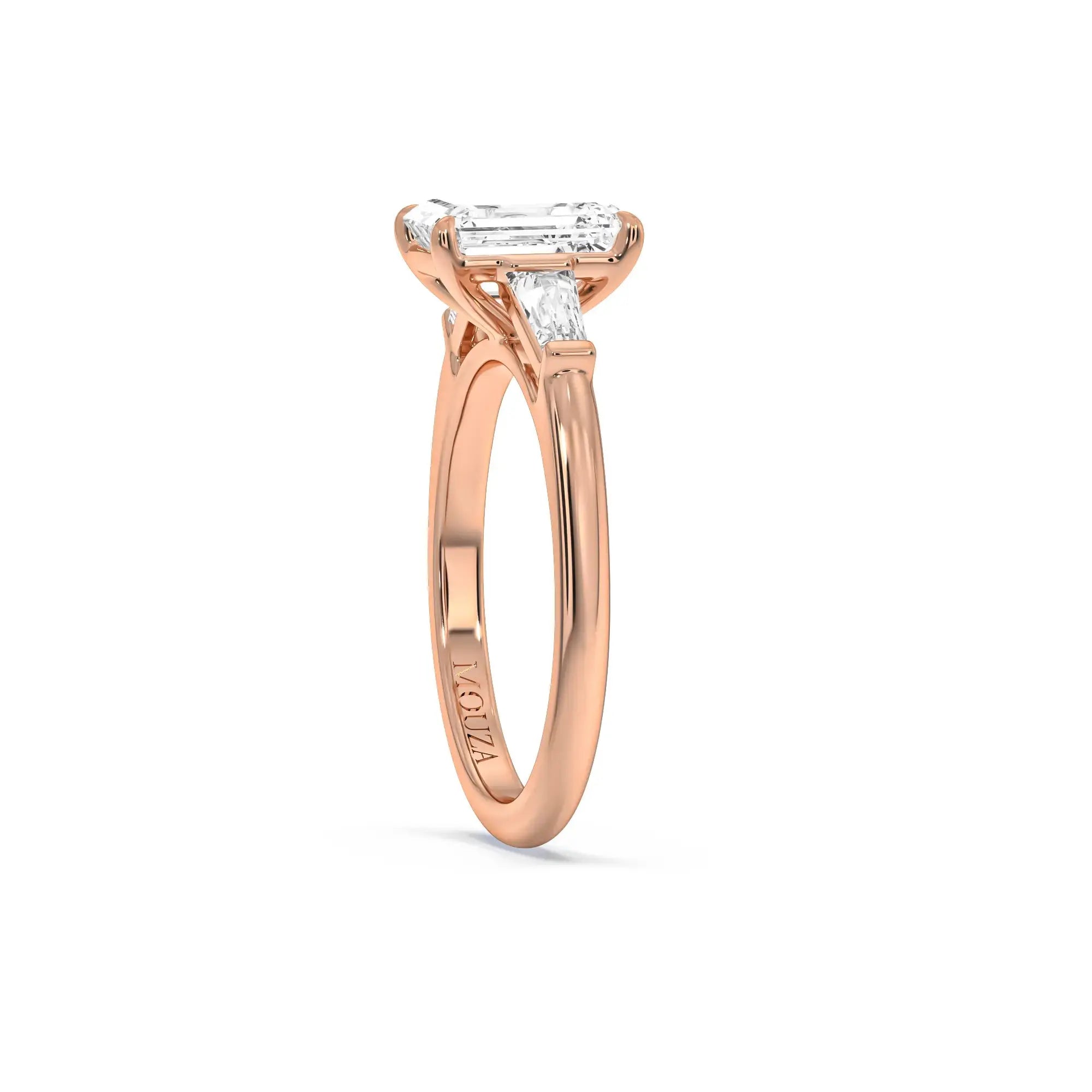 A sleek and timeless emerald-cut diamond engagement ring in a rose gold band from Mouza