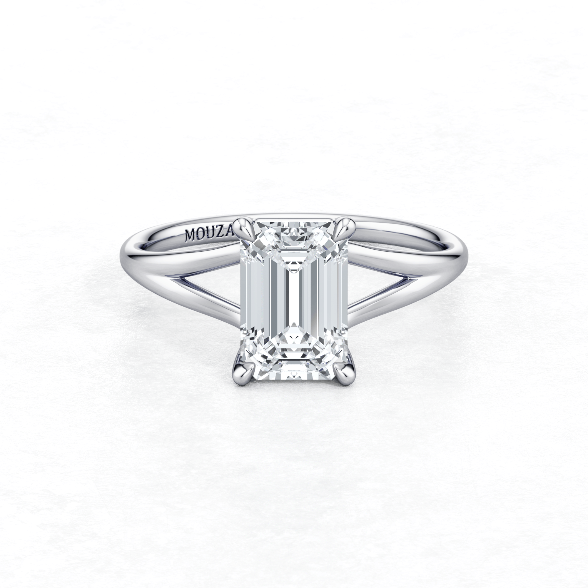Elegant White Gold Maggy Solitaire Engagement Ring having a sleek design from Mouza with brand name engraved on the metal band.