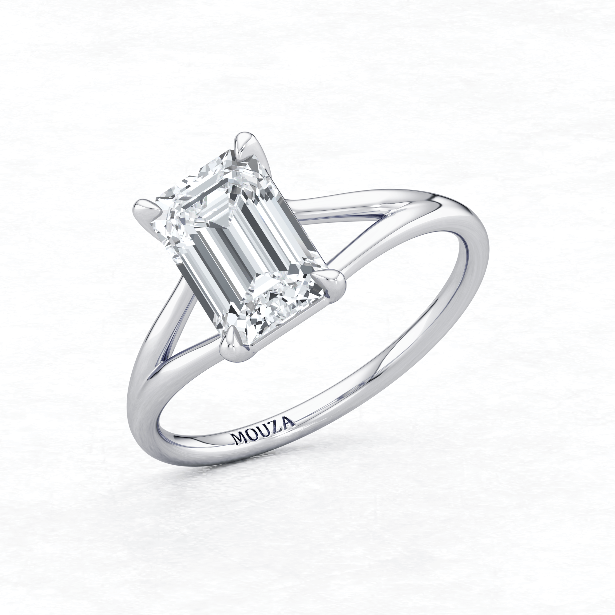Elegant White Gold Maggy Solitaire Engagement Ring having a sleek design and brand name Mouza engraved on the metal band.