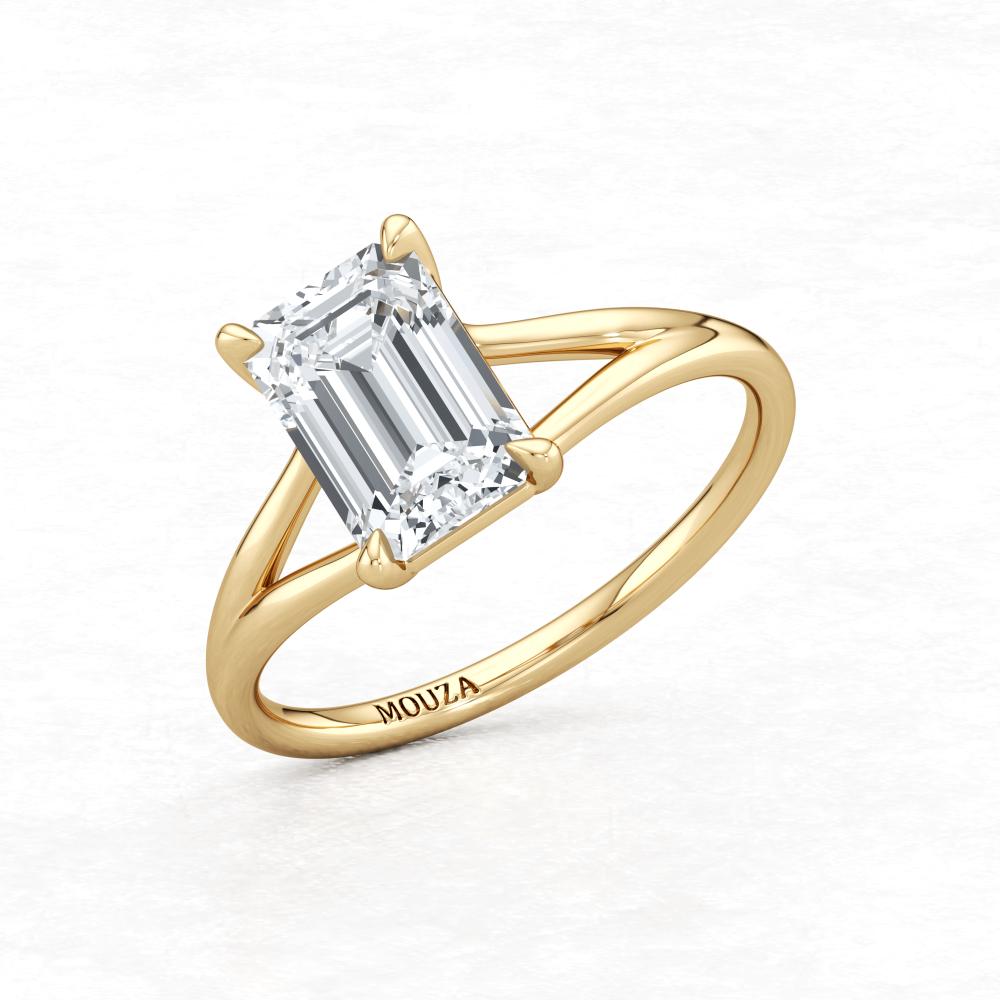 Yellow Gold Maggy Solitaire Engagement Ring having a sleek and contemporary design with brand name Mouza engraved on it
